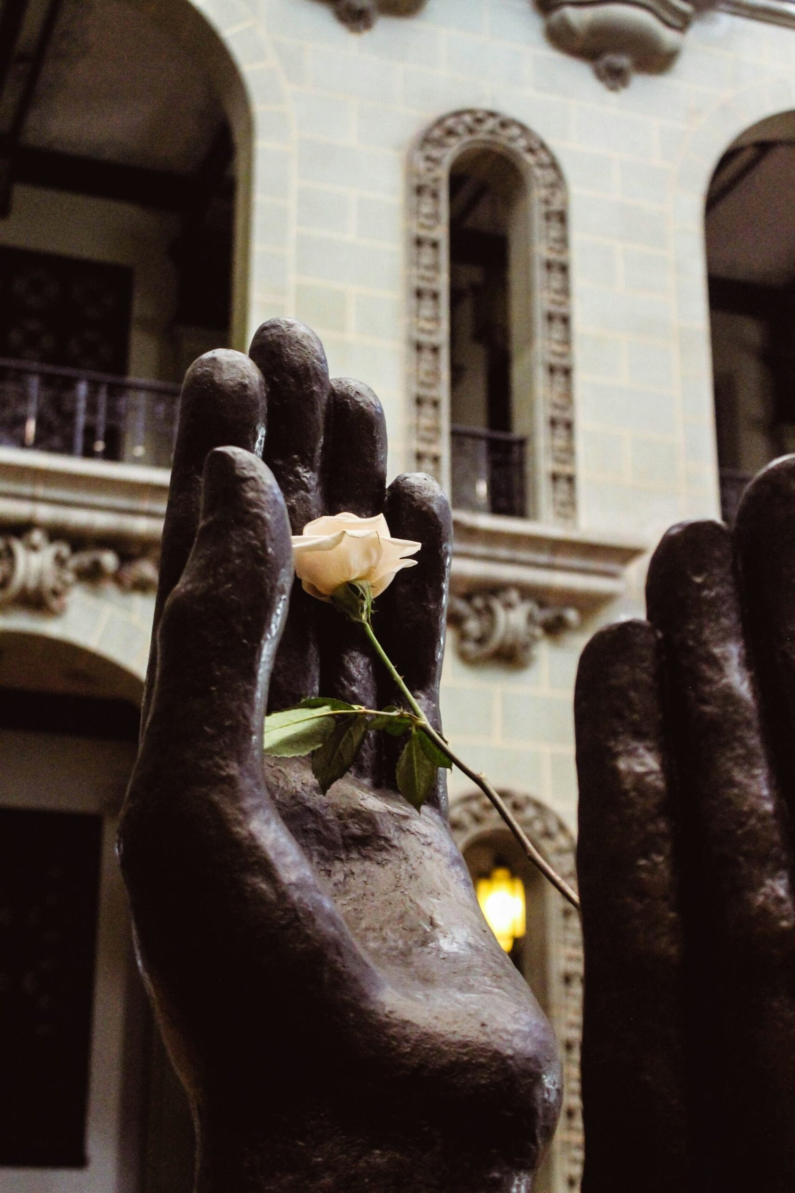 a statue of a hand holding a rose
